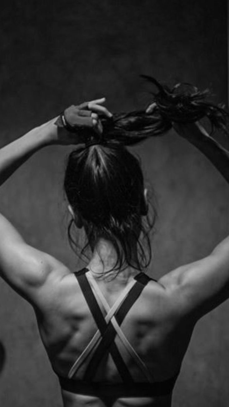 Member tying her hair back before a session in the infrared studio